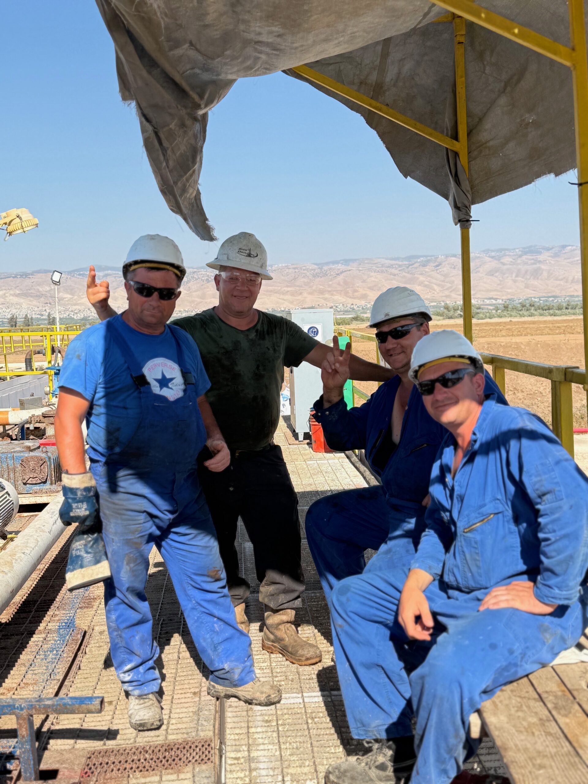 Smiling MJ-02 crew members at the drilling site