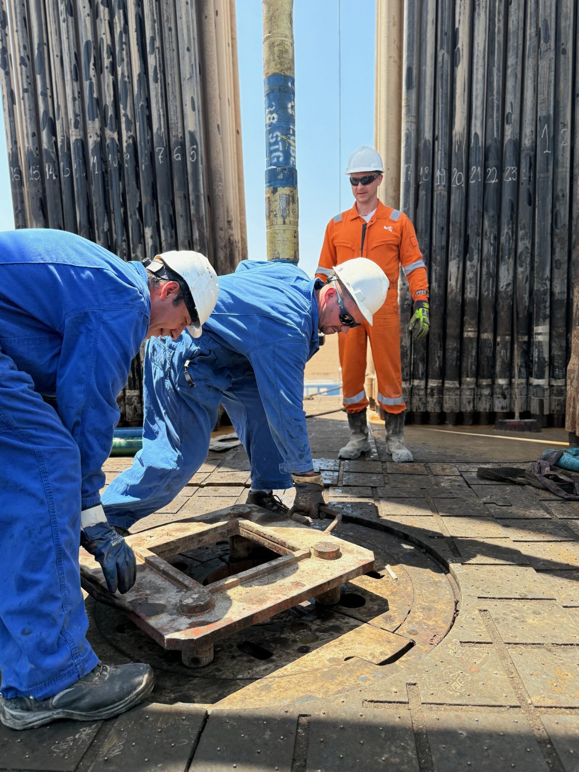 MJ-02 crew coordinating work on the drilling floor