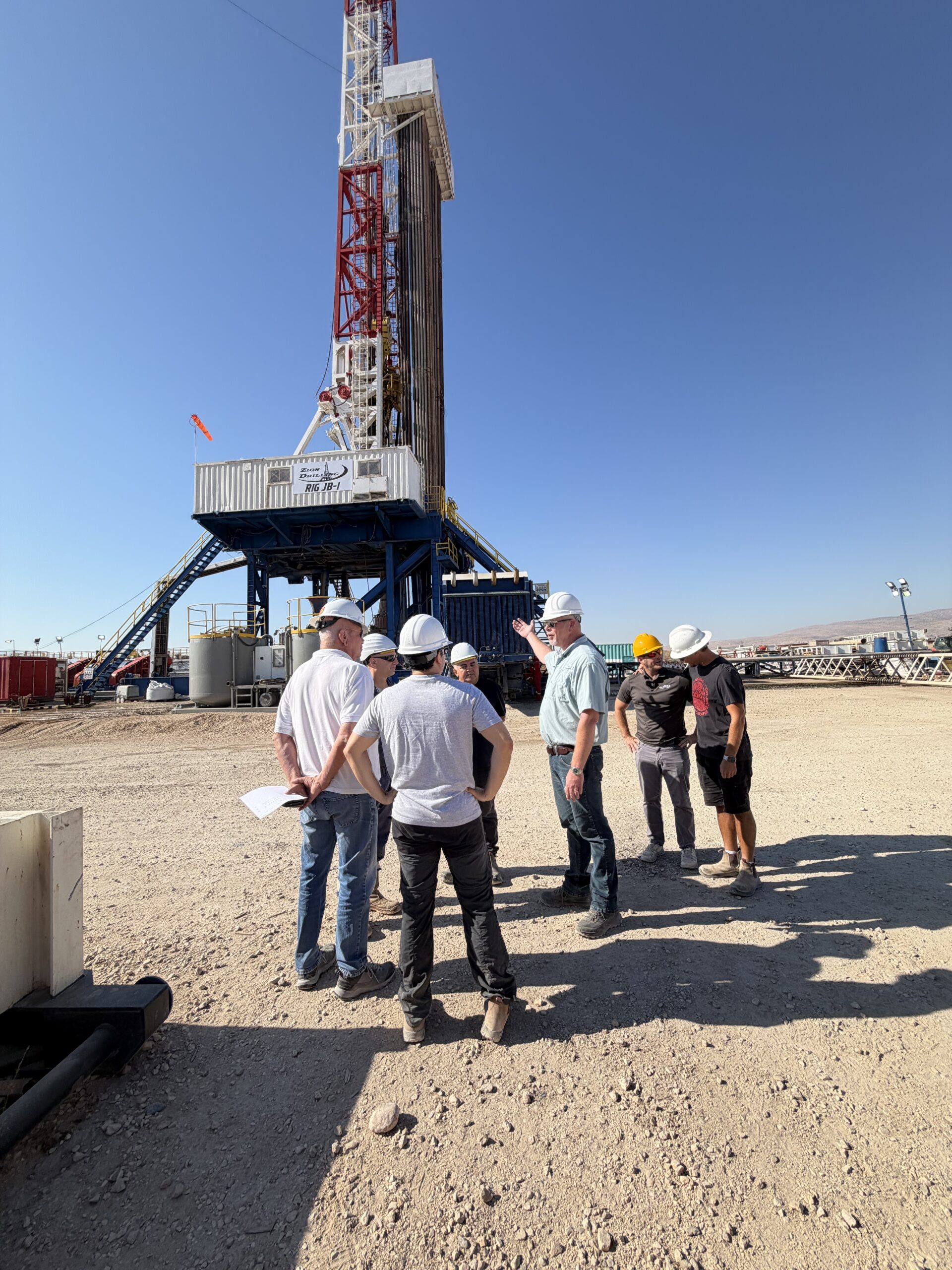 Rob Dunn speaking with team members at the MJ-02 site