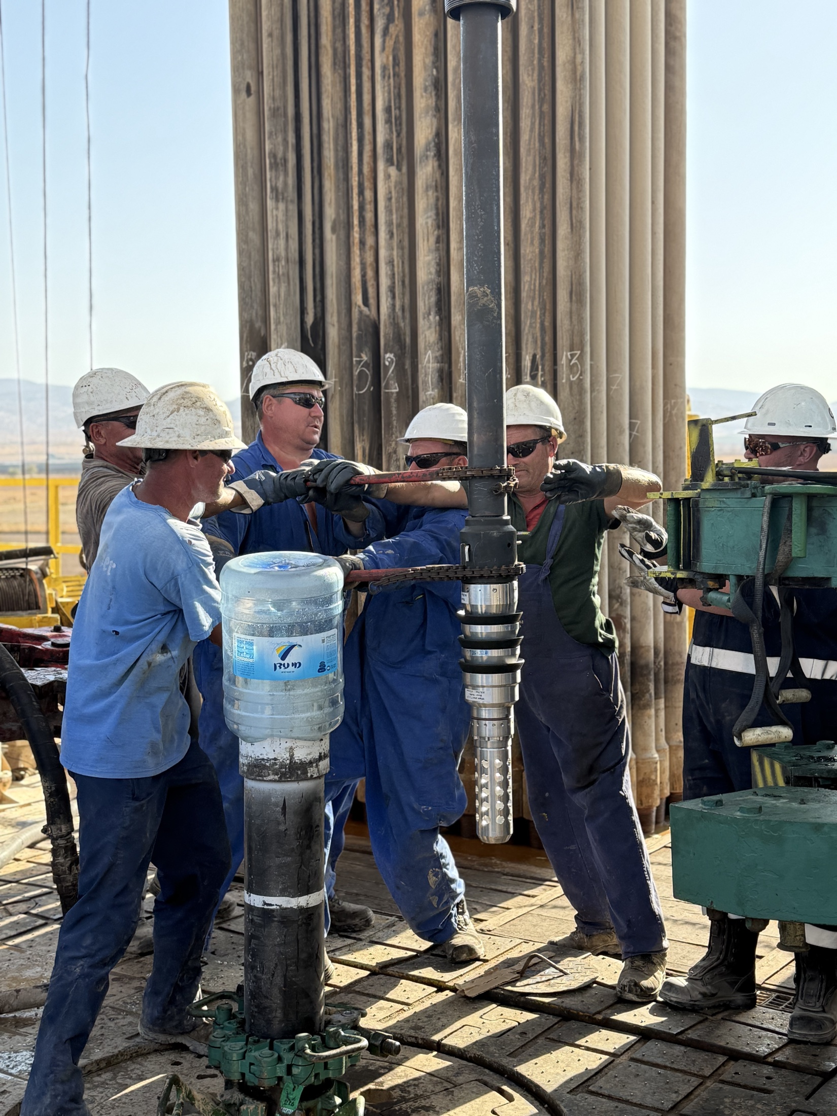 MJ-02 crew coordinating work around a pipe connection