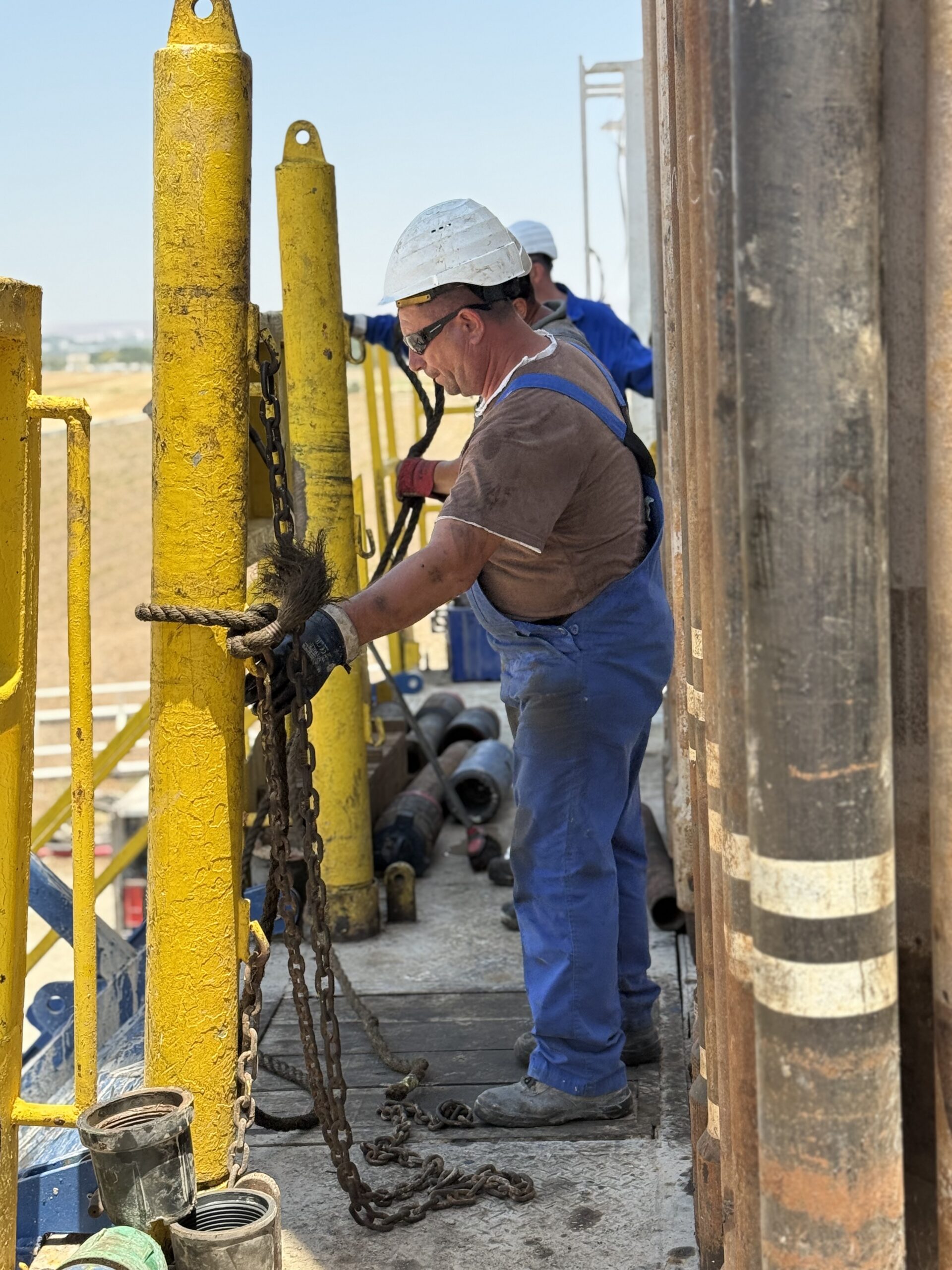 MJ-02 crew member preparing equipment on the rig floor